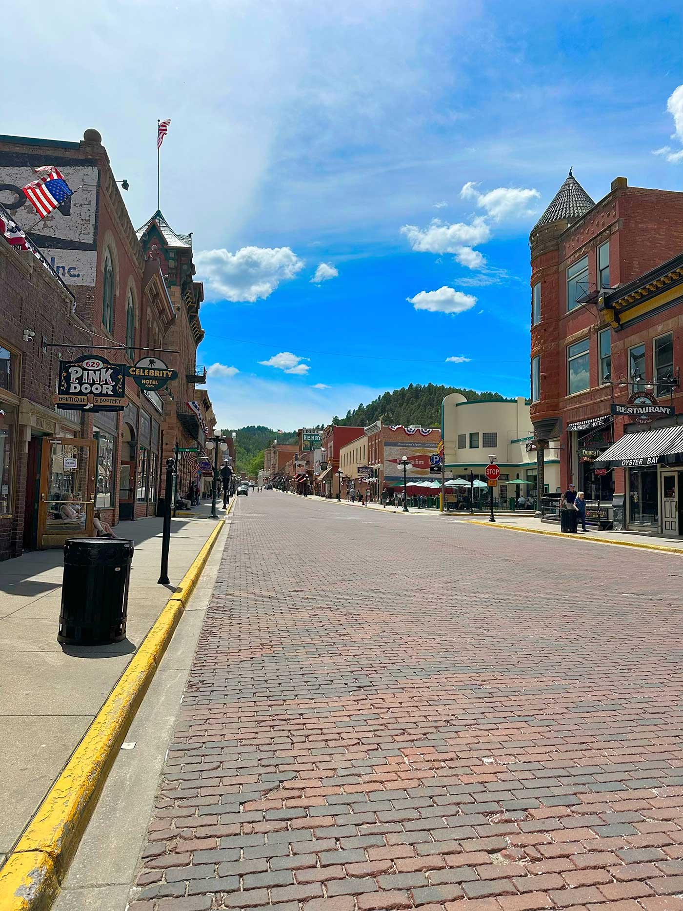 Brick-paved street lined with historic buildings in downtown Deadwood, South Dakota.