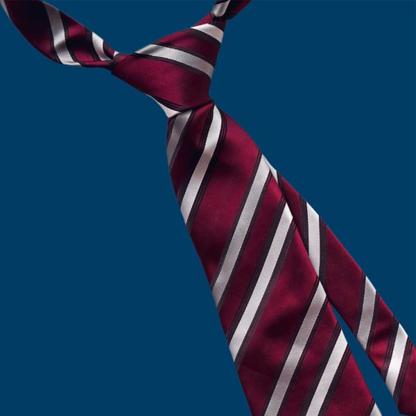 Picture featuring a striped necktie on a blue background.