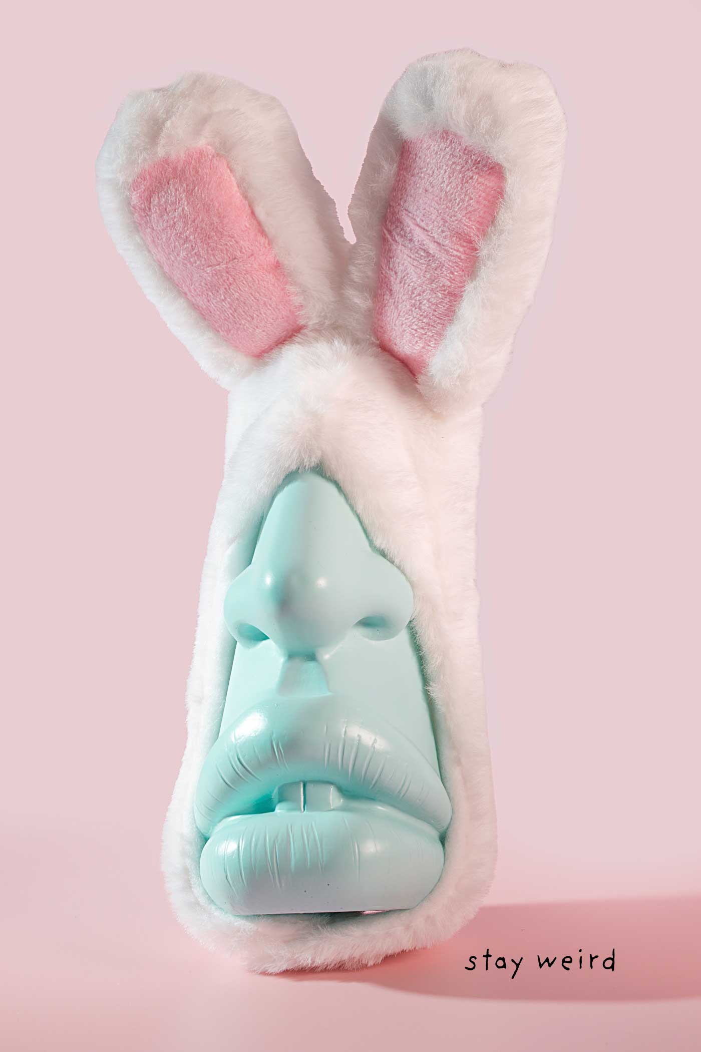 Whimsical bunny sculpture with long ears and a mint green face