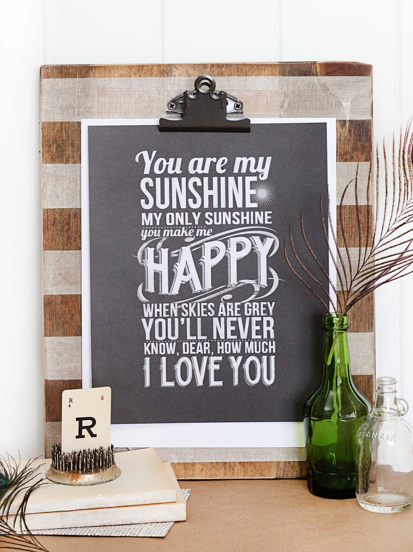 DIY wooden photo clipboard with striped finish holding a printable quote