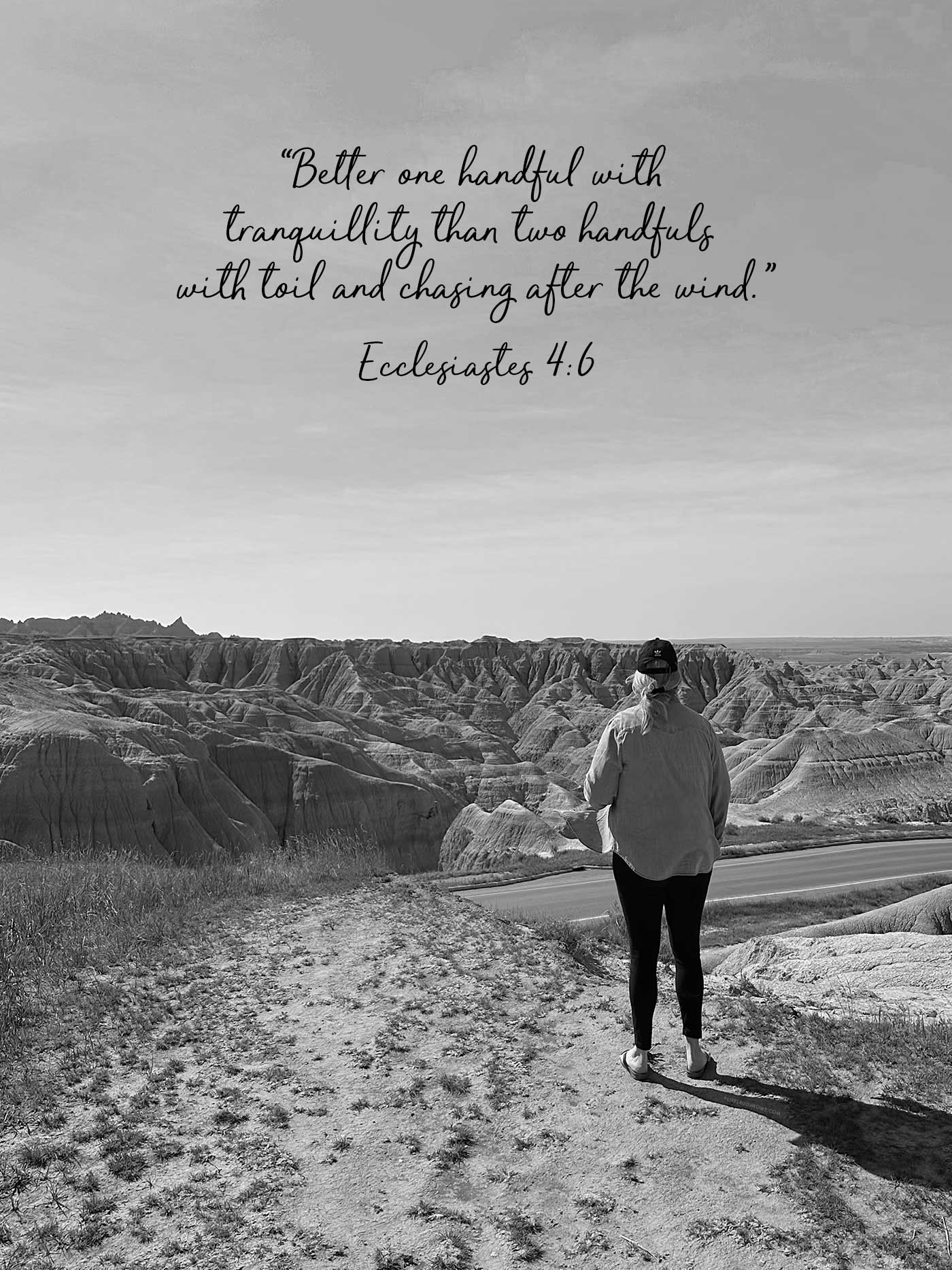 Black-and-white landscape with a person overlooking the Badlands and Ecclesiastes 4:6, &ldquo;Better one handful with tranquillity than two handfuls with toil and chasing after the wind.&rdquo;