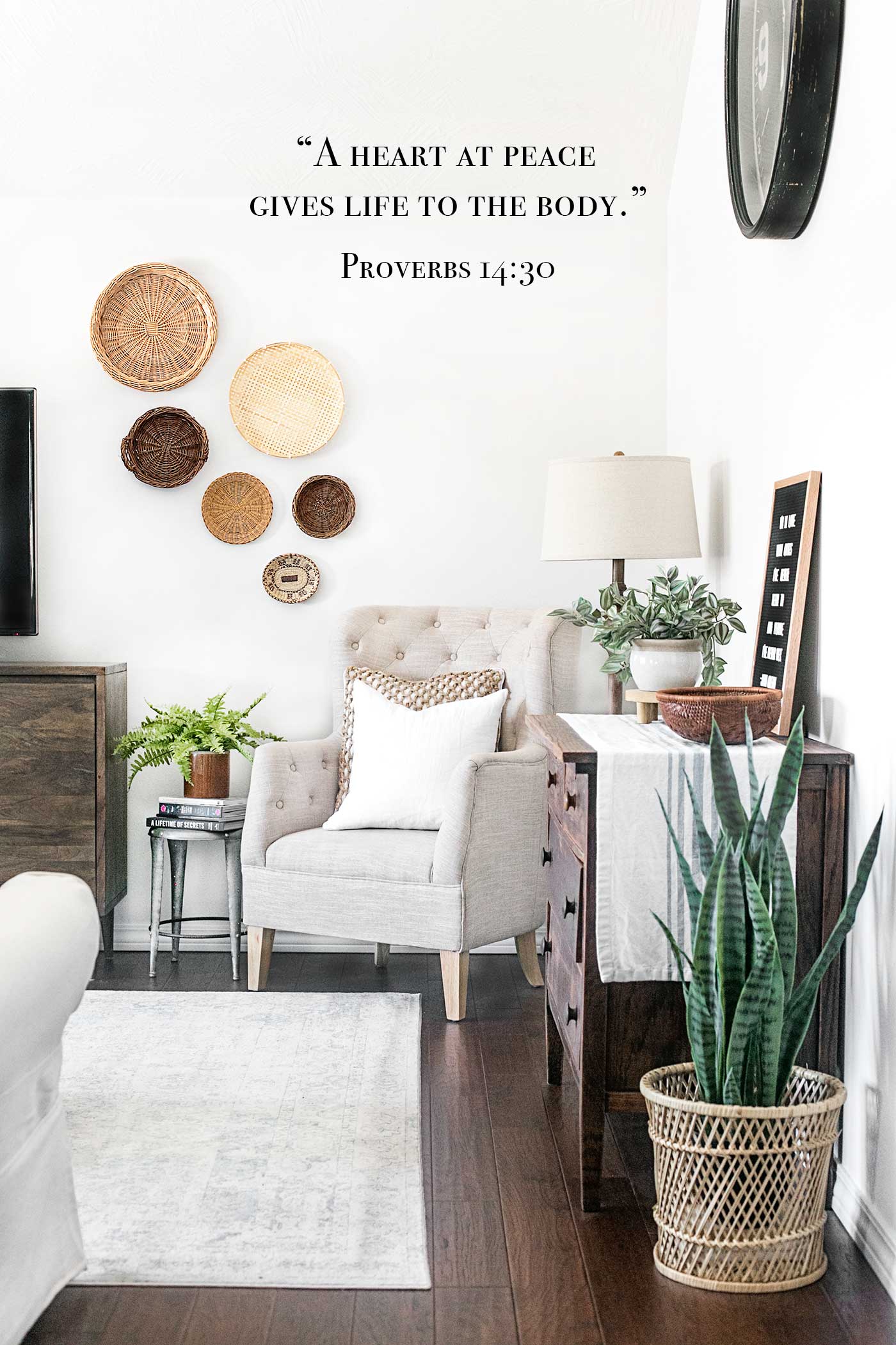 Bright peaceful living room with neutral decor and the Bible verse Proverbs 14:30, &ldquo;A heart at peace gives life to the body.&rdquo;