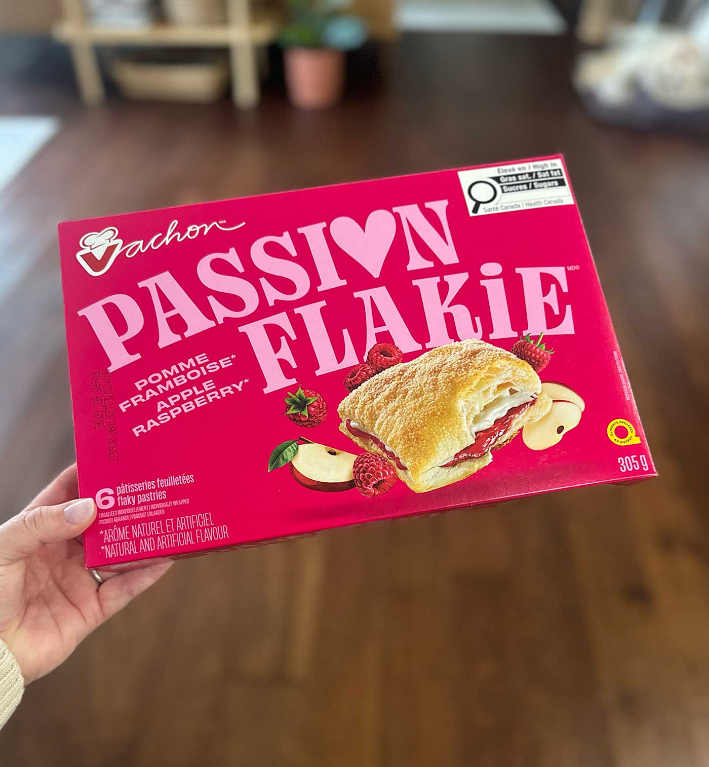 Hand holding a box of Vachon Passion Flakie apple and raspberry pastries.