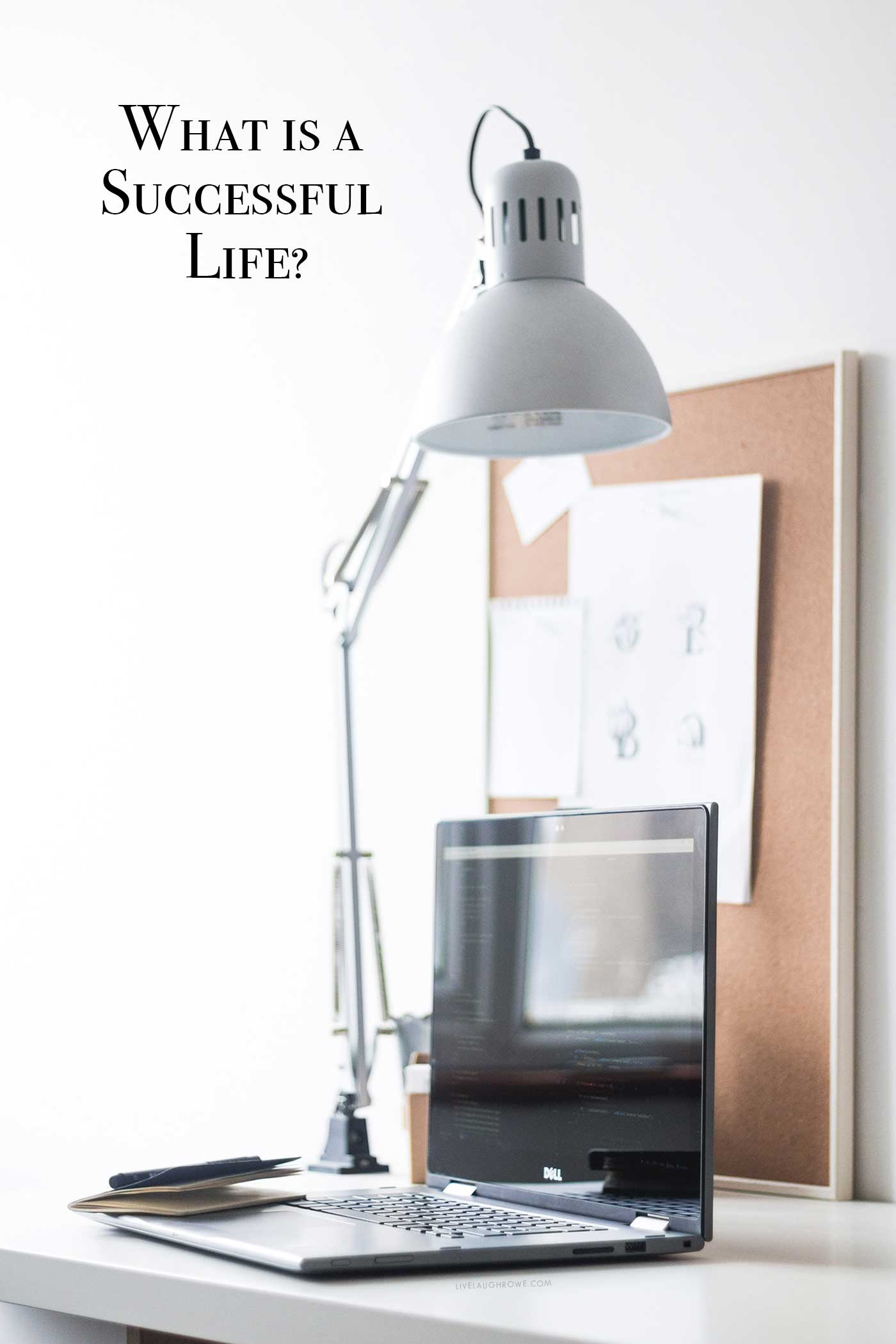 Bright home office with a laptop, desk lamp, and the text &ldquo;What Is a Successful Life?&rdquo;