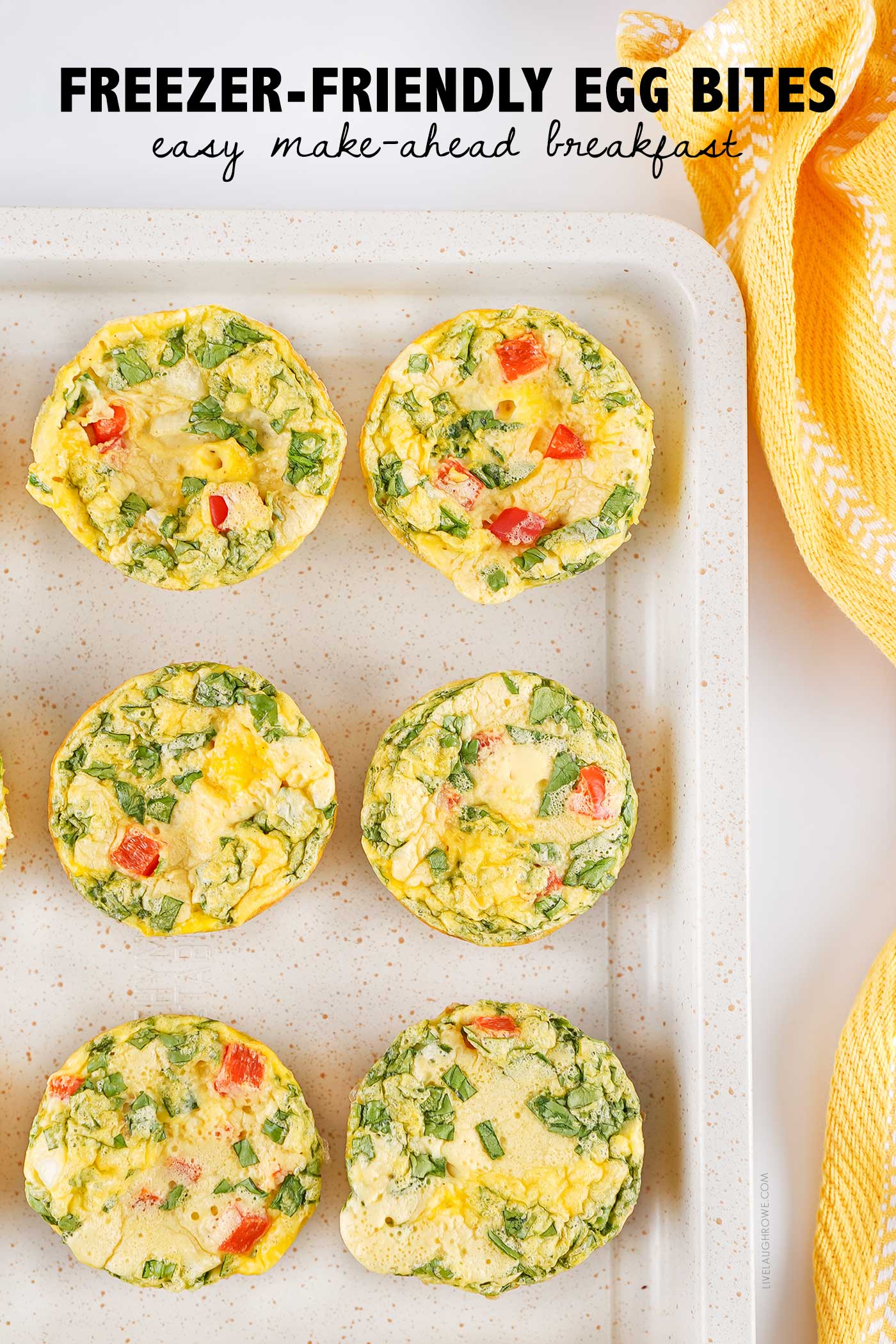 Cottage cheese egg bites with spinach and red bell pepper arranged on a baking sheet