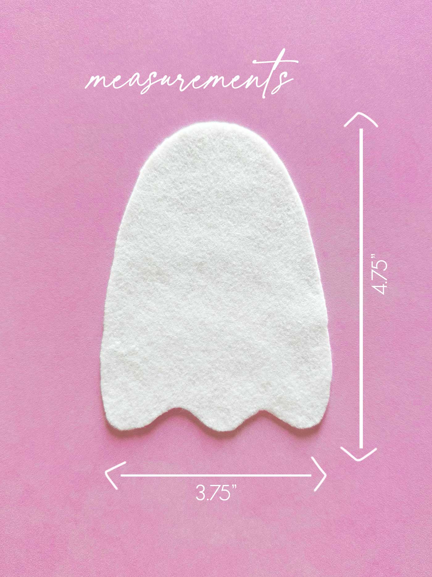 White felt ghost shape cut from a handmade ghost template on a pink background