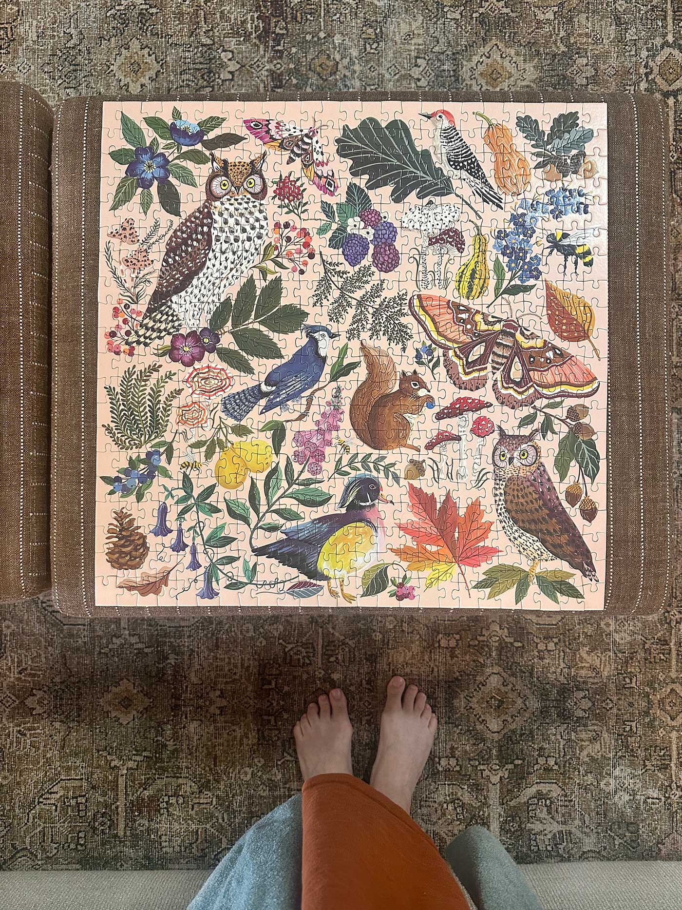 Completed woodland jigsaw puzzle on a puzzle board viewed from above